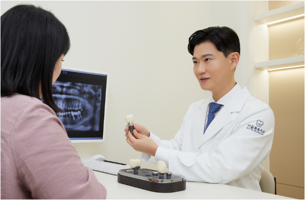Dr. Sangeok Park — explaining treatment options with X-ray and dental model